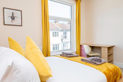 a bedroom with a large white bed and a window at Modern Home Near South Parade Pier in Portsmouth