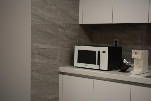 a microwave sitting on a counter in a kitchen at Beautipool Pension in Jeju