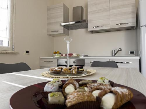 a plate of pastries on a table in a kitchen at Athena Agrigento Apartments in Agrigento