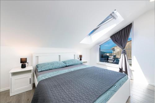 a white bedroom with a bed and a window at Apartment Ivan in Dubrovnik