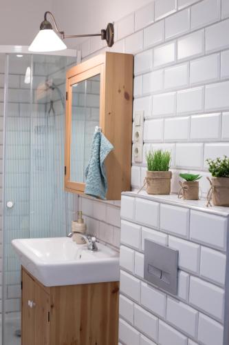 a bathroom with a sink and a mirror at Kúria Apartman Budapest with free parking in Budapest