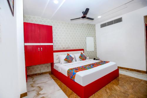 a bedroom with a red bed and a red cabinet at FabHotel Golden Temple Paradise - 50 meters from Golden Temple in Amritsar