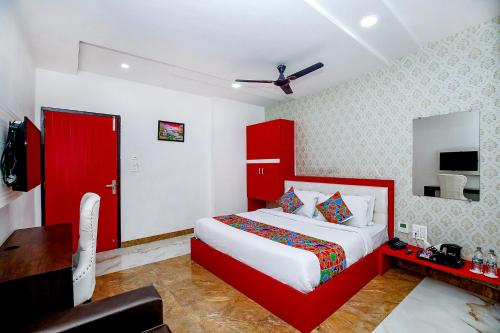 a bedroom with a red bed and a red door at FabHotel Golden Temple Paradise - 50 meters from Golden Temple in Amritsar