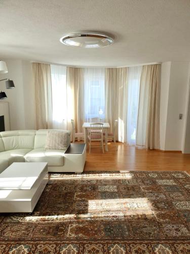 a living room with a white couch and a table at Blackforest FeWo in Freudenstadt