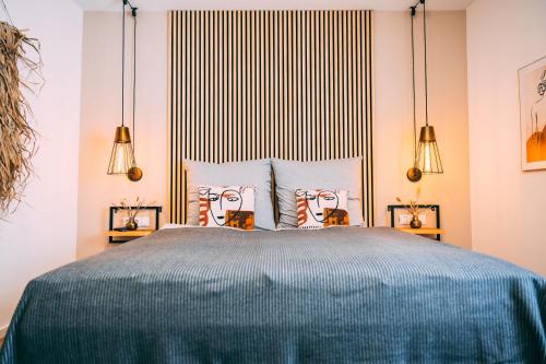 a bedroom with a large bed with two lamps at Premium Apartments Koblenz in Koblenz