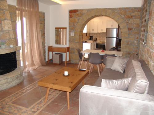 a living room with a couch and a table at Kolokotronis Hotel & Spa in Stoupa
