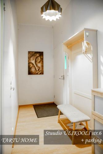 a living room with a chair and a painting on the wall at University City Heart, Tartu Home in Tartu