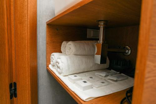a shelf with towels on it in a room at Apart-hotel Dream in Málaga