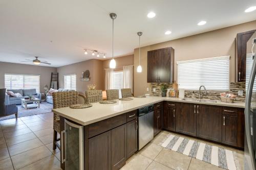 a kitchen with wooden cabinets and a living room at Pet-Friendly Phoenix Condo with Community Amenities in Phoenix