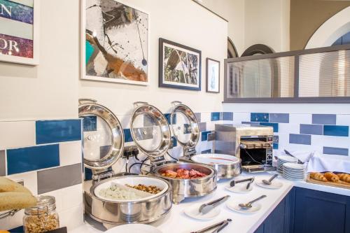 a kitchen with several pans of food on a counter at Park House Hotel in Shifnal