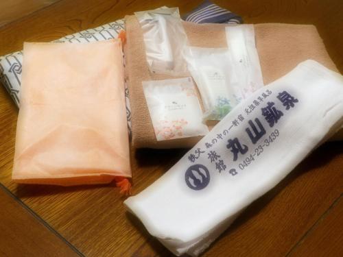 a table with two bags with writing on it at 丸山鉱泉旅館 in Nitanzawa