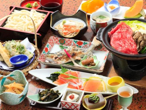 a table with a bunch of different plates of food at 丸山鉱泉旅館 