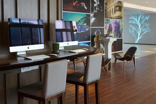 a room with a computer desk and a projector screen at Radisson Hotel Kandy in Kandy