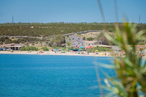 a view of a beach with a group of people at Apartments Ostrea - Caska in Novalja