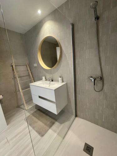 a bathroom with a white sink and a mirror at Guiri Casilla de Costa Villaverde in Villaverde