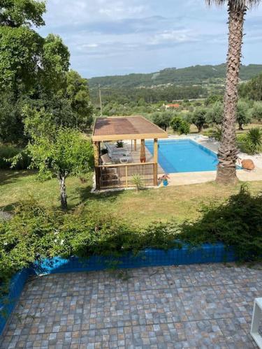 a house with a gazebo and a swimming pool at Quinta Inge in Paio Mendes