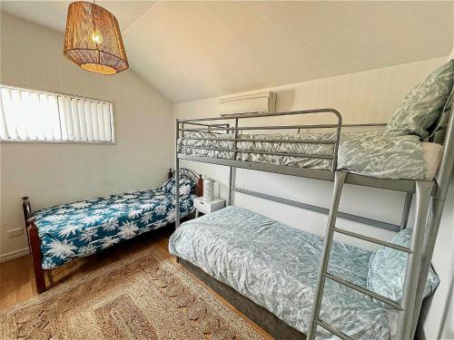 a bedroom with two bunk beds and a rug at Sea Salt at Stansbury Apartment 3 in Stansbury