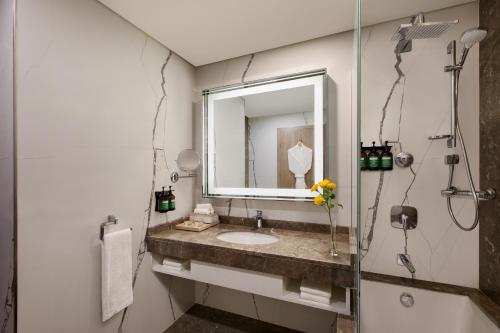 a bathroom with a sink and a mirror at voco Dubai The Palm by IHG in Dubai