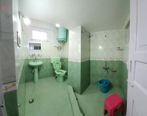 a bathroom with a sink and a toilet and a sink at Home Sweet Home in Srinagar