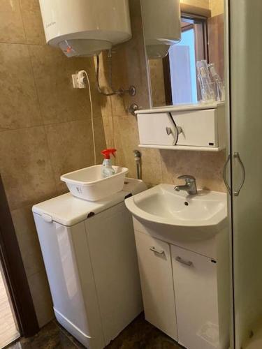 a small bathroom with a sink and a mirror at Apartment in Becici in Bečići