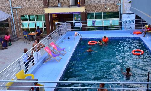 a group of people in a swimming pool on a cruise ship at 1 Bedroom Short Let Apartment-Hotel Penthouse in Lekki