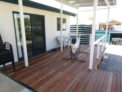 a deck with a bench on a house at The Shack at Hardwicke in Hardwicke Bay