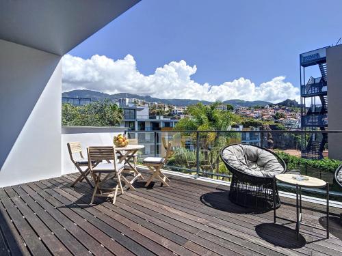 a balcony with a table and chairs on a building at Funchal Frui Vita by Atlantic Holiday in Funchal