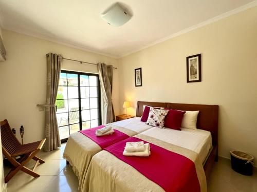 a bedroom with a large bed with towels on it at Pêra Brightness Villa by Homing in Pêra