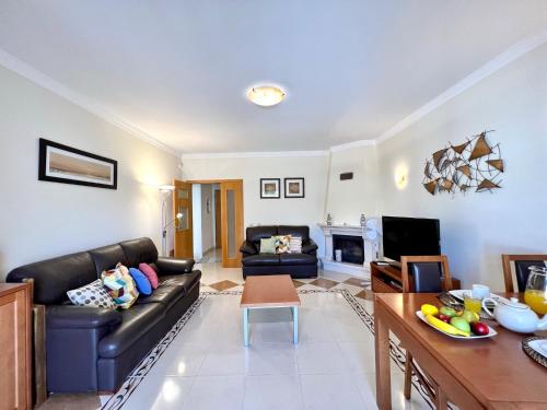 a living room with a couch and a table at Pêra Brightness Villa by Homing in Pêra