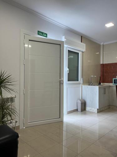 a door with a exit sign on it in a room at Casa Cancela in Palas de Rei 