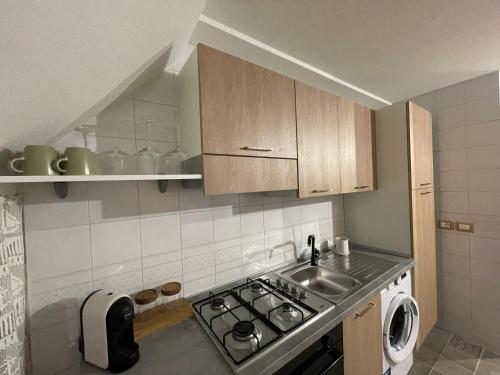 a small kitchen with a stove and a sink at AngeLina al borgo in Aieta