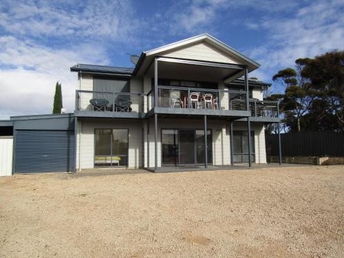 a house with a balcony with chairs on it at Lady Doris in Port Vincent