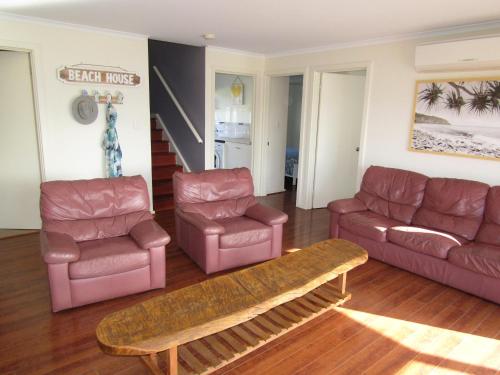a living room with a couch and chairs and a table at Lady Doris in Port Vincent