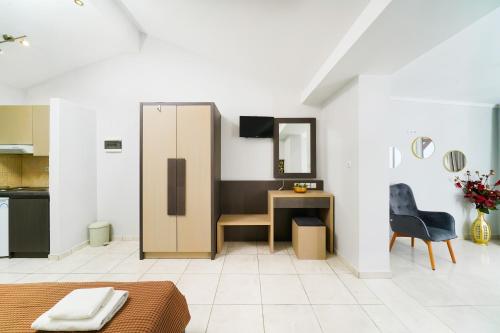 a living room with a desk and a mirror at Villa Irene in Skala Marion