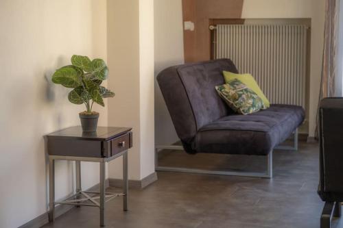 a purple chair sitting next to a table with a plant at Nouveau - Le Baby Player - Europa Park in Huttenheim