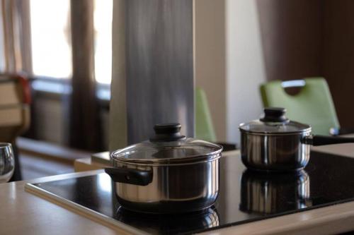 two pots sitting on top of a stove at Nouveau - L'Entre Nous - Europa Park in Huttenheim