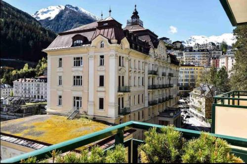 a large building in a city with a mountain at Brand-new, central apartment w/ VIEWS in Bad Gastein