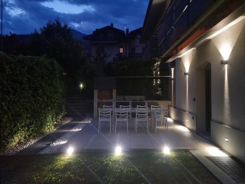 a patio at night with chairs and lights at Suite vacanze Chabloz nel cuore della Valle d'Aosta in Nus