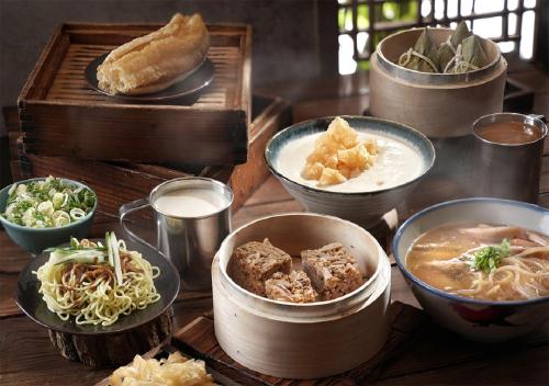 a table with bowls of food and a box of food at Palais de Chine Hotel in Taipei