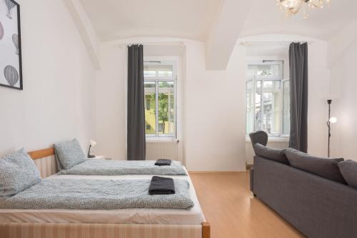 a living room with a bed and a couch at Spacious APT in Perfect Location for Family 24h Check-in in Vienna