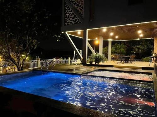 a swimming pool in the middle of a house at night at 1992 Tam Đảo - Venuestay in Tam Ðảo