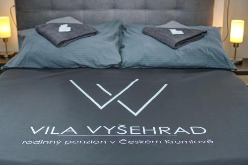 a bed with two pillows on top of it at Vila Vyšehrad in Český Krumlov