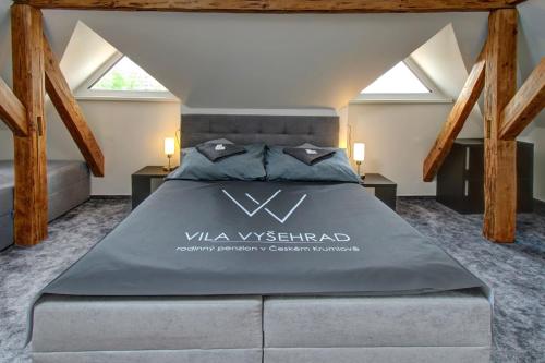 a large bed in a room with skylights at Vila Vyšehrad in Český Krumlov