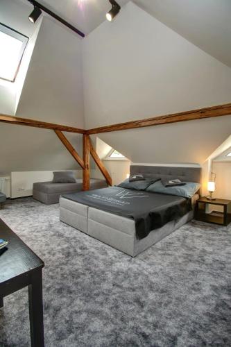 a bedroom with a large bed in a attic at Vila Vyšehrad in Český Krumlov