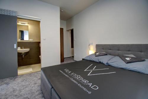 a bedroom with a bed with a welcome sign on it at Vila Vyšehrad in Český Krumlov