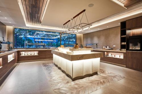 a hotel lobby with a counter and a large window at Silken Platja d'Aro in Platja  d'Aro