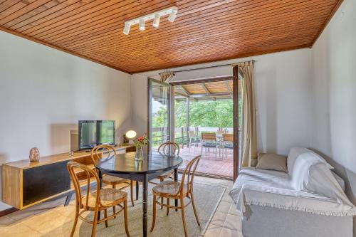 a living room with a table and chairs and a bedroom at Lovely House Near Zagreb With Terrace - Happy Rentals in Graberje Ivanićko