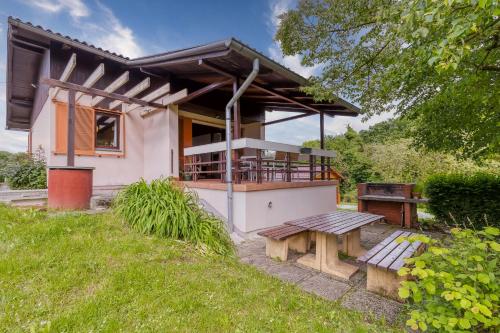 a house with a picnic bench in front of it at Lovely House Near Zagreb With Terrace - Happy Rentals in Graberje Ivanićko