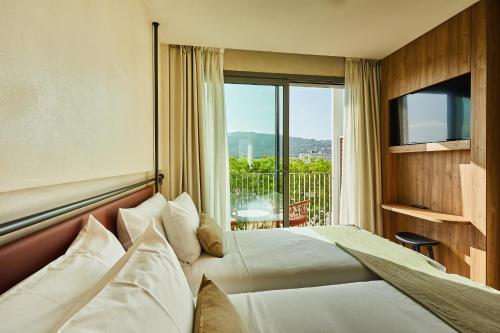 a hotel room with a bed and a balcony at Silken Platja d'Aro in Platja  d'Aro