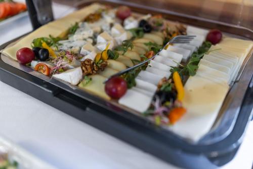 a tray of food on a table with vegetables at Hotel Opera in Sopot